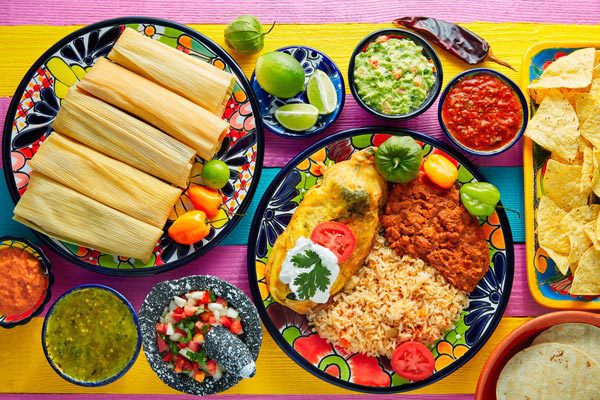 La Chalupa Lancaster Mexican food on colorful plate and table including tamales, rice and beans, dips and sauces